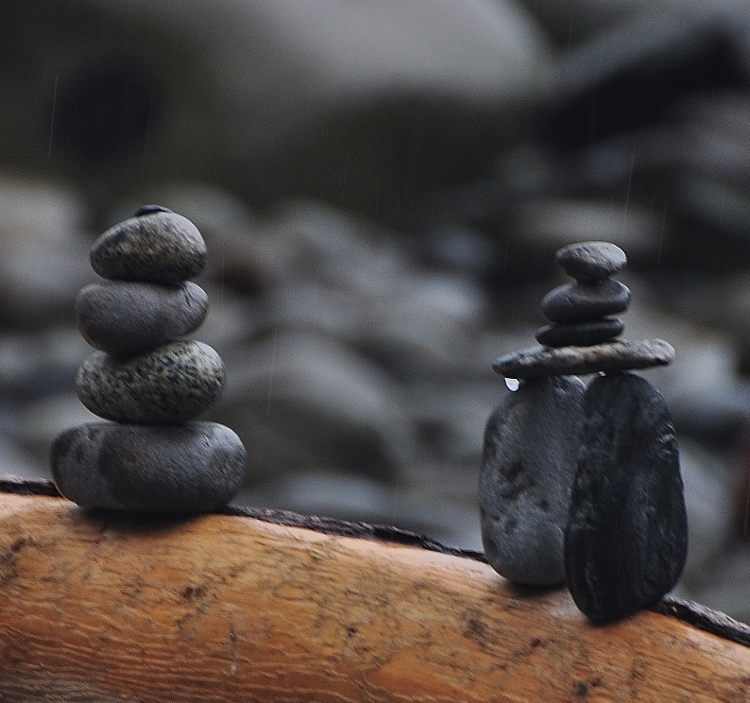 two small cairns on a log